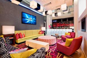 a lobby with a couch and chairs and a table at Aloft Manhattan Downtown - Financial District in New York