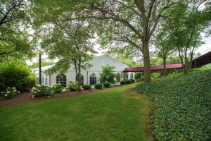 a white barn with trees and a yard at Chicago Marriott Schaumburg in Schaumburg