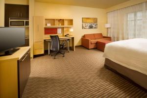 a hotel room with a bed and a desk at TownePlace Suites by Marriott Dallas DFW Airport North/Grapevine in Grapevine