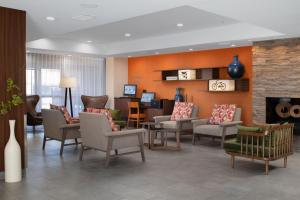 a waiting room with chairs and a fireplace at Fairfield by Marriott Inn & Suites Fossil Creek in Fort Worth