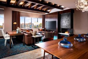 a hotel room with a fireplace and a living room at The Westin Buffalo in Buffalo