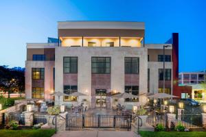 a building with tables and umbrellas in front of it at Courtyard by Marriott Niagara Falls, USA in Niagara Falls