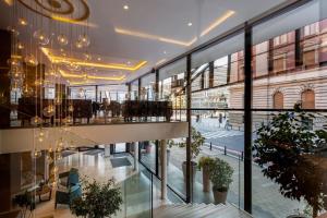 Blick auf die Lobby eines Gebäudes mit großen Fenstern in der Unterkunft Courtyard by Marriott Belgrade City Center in Belgrad