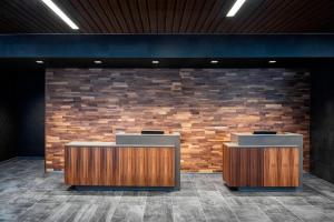 a lobby with two desks and a brick wall at Courtyard by Marriott Albany Troy/Waterfront in Troy
