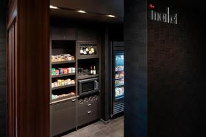 a kitchen with an open refrigerator with food at Courtyard by Marriott Albany Troy/Waterfront in Troy