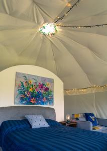 a bedroom with a bed and a ceiling with lights at Little River Glamping in Ballymoney