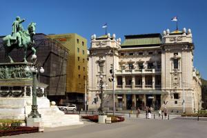 a statue of a man on a horse in front of two buildings at Courtyard by Marriott Belgrade City Center in Belgrade