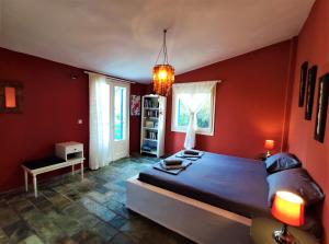 a bedroom with red walls and a large bed at I GABBIANI in Pefkochori