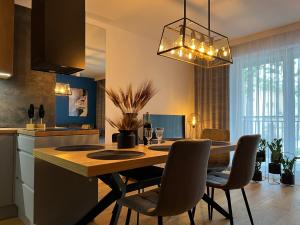 a kitchen and dining room with a table and chairs at Family & Business Elegant Apartments, Kadzielnia, WDK, Stadion Korona -1 Bedroom, Terrace, Garage, NEW! in Kielce