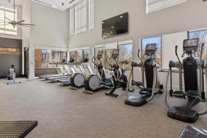 a gym with rows of treadmills and ellipticals at Kasa Union Station Denver in Denver