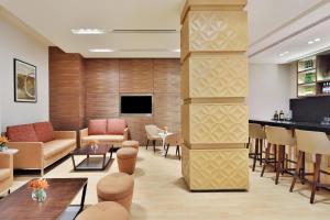 a lobby of a hotel with furniture and a bar at Fairfield by Marriott Amritsar in Amritsar