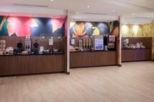 a lobby of a hotel with a bar and a counter at Fairfield Inn & Suites by Marriott Augusta Washington Rd./I-20 in Augusta