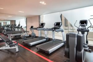 a gym with treadmills and elliptical machines at Sheraton Bratislava Hotel in Bratislava