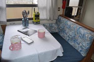 a table with a white table cloth and two cups at The blue rooster 