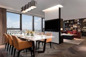 a dining room with a table and chairs and a large window at Courtyard by Marriott Changsha South in Changsha