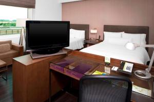 sypialnia z biurkiem, telewizorem i łóżkiem w obiekcie Element Dallas Fort Worth Airport North w mieście Irving