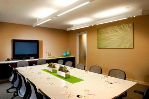 a conference room with a table and chairs and a screen at Element Dallas Fort Worth Airport North in Irving