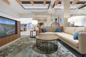 a living room with a couch and a table at Courtyard by Marriott Marina del Rey in Los Angeles