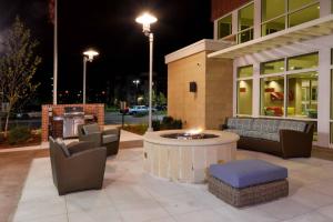 a patio with chairs and a fire pit in front of a building at Residence Inn by Marriott Omaha Aksarben Village in Omaha