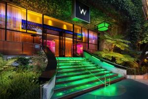 a set of green stairs in front of a building at W Los Angeles – West Beverly Hills in Los Angeles