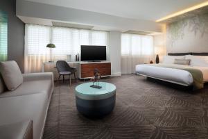 a hotel room with a bed and a couch at W Los Angeles – West Beverly Hills in Los Angeles