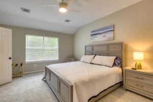 a bedroom with a large bed and a window at Modern Woodlands Townhome with Spacious Yard and Patio in The Woodlands