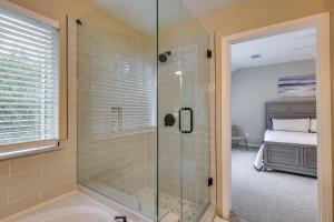 a bathroom with a shower with a glass door at Modern Woodlands Townhome with Spacious Yard and Patio in The Woodlands +21 photos