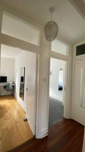 a living room with a hallway with a pendant light at 2 Bedroom Flat in Camberwell Green - Central Location with excellent connections to tourist attractions and main London airports in London