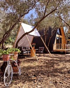 a tent with a bike parked in front of it at GÖCEK BUNGALOW in Göcek