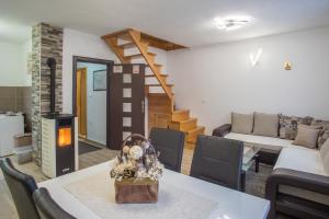 a living room with a table and a fireplace at Vacation Home Danilo in Žabljak