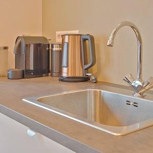a kitchen counter with a sink and a coffee maker at PRIVATE APPARTMENT 60m2 - CENTRE TOP LOCATION in Amsterdam