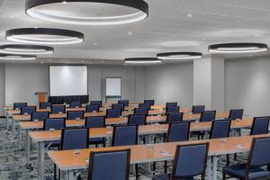 a conference room with tables and chairs and a screen at Fairfield Inn & Suites by Marriott New York Manhattan/Times Square South in New York