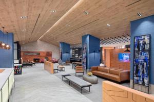 a lobby with couches and tables in a building at Fairfield Inn & Suites by Marriott New York Manhattan/Times Square South in New York