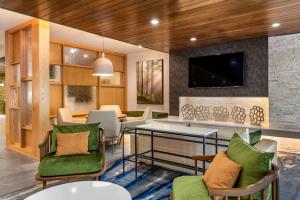a living room with a table and chairs at Fairfield Inn & Suites by Marriott Helen in Helen