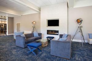 sala de estar con sofás y chimenea en Four Points by Sheraton Eastham Cape Cod, en Eastham