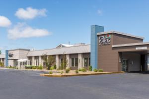 a front view of a hotel with a parking lot at Four Points by Sheraton Eastham Cape Cod in Eastham