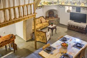 a living room with a table and a couch and a fireplace at Stone Arch in Malona Village