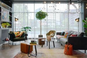 a living room with a couch and a table at Moxy Bristol in Bristol