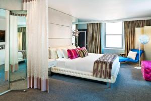 a hotel room with a bed and a mirror at W Chicago - City Center in Chicago