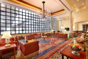 a lobby with couches and tables and a large window at ITC Maratha, a Luxury Collection Hotel, Mumbai in Mumbai