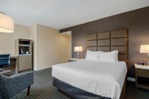 ein Hotelzimmer mit einem Bett und einem Stuhl in der Unterkunft Best Western Premier Chateau Granville Hotel & Suites & Conference Centre in Vancouver