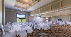a banquet hall with white tables and white chairs at Prestige Harbourfront Resort, WorldHotels Luxury in Salmon Arm +82 photos