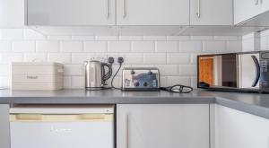 a kitchen counter with appliances on a counter top at Ullswater at the Graythwaite Estate in Ambleside +19 photos