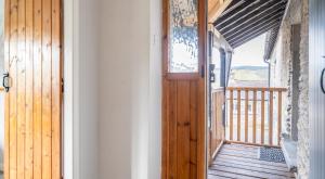 a wooden door leading to a porch with a deck at Ullswater at the Graythwaite Estate in Ambleside