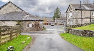 a street in a village with stone buildings at Ullswater at the Graythwaite Estate in Ambleside