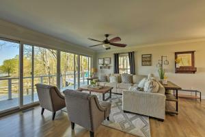 a living room with a couch and a ceiling fan at Riviera Paradise with Private Dock! home in Mooresville