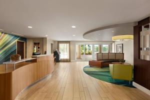 a lobby of a hotel with a waiting area and a couch at SpringHill Suites Boca Raton in Boca Raton