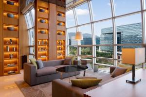 a living room with a couch and a table at Courtyard by Marriott Seoul Pangyo in Seongnam