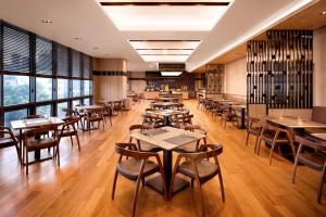 a restaurant with tables and chairs and windows at Fairfield by Marriott Seoul in Seoul
