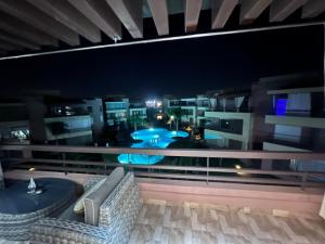 a balcony with a view of a city at night at Appart avec Piscine, Riad Garden in Marrakech